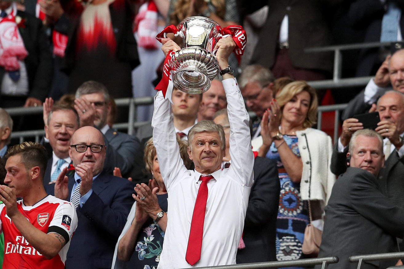 Arsene Wenger lifts the FA Cup trophy on the weekend. Photo: Adam Davy / PA Wire
