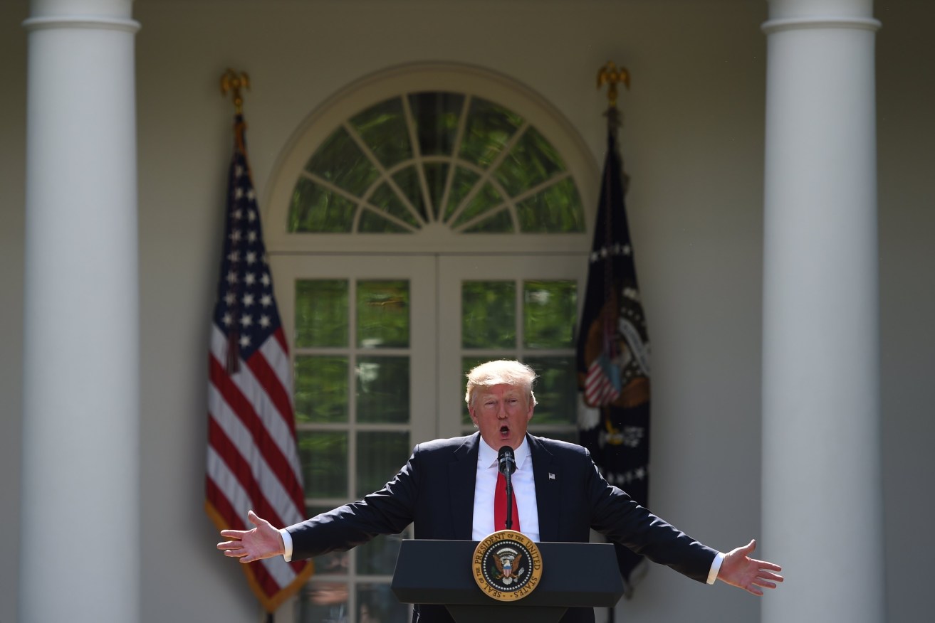 President Donald Trump, at the White House, announces that the US is withdrawing from the Paris climate accord. Photo: EPA/Molly Riley