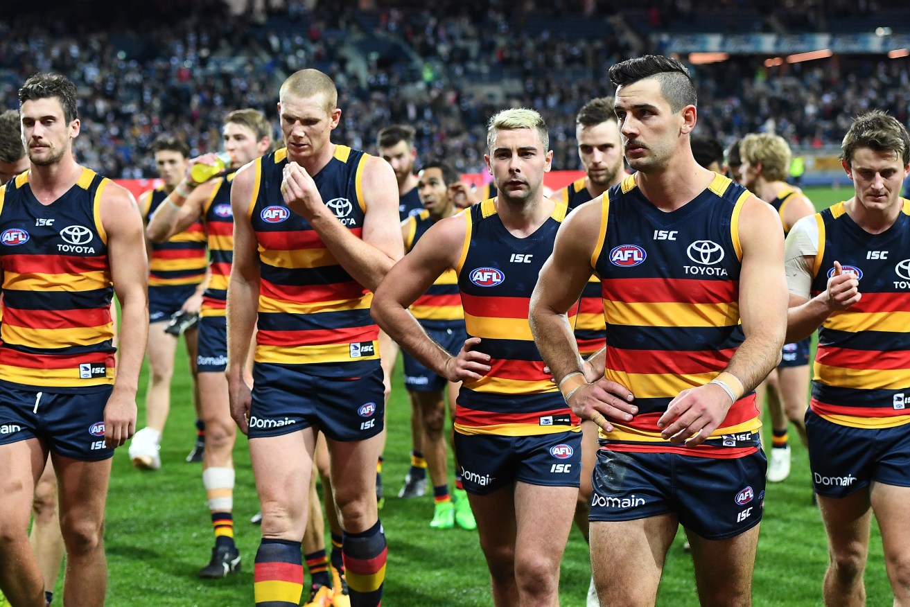 Walker leads the Crows from the field after their loss to Geelong. Photo: Julian Smith / AAP