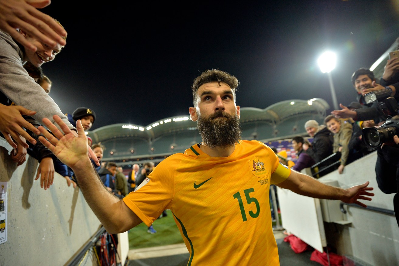 Mile Jedinak, leaving the field after Australia's win over Saudi Arabia at Adelaide Oval, has been sent home to rehabilitate from a groin injury. Photo: David Mariuz / AAP