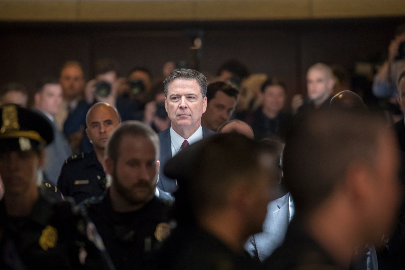 Former FBI director James Comey walks through a corridor on the way to a secure room to continue his testimony. Photo: AP/J. Scott Applewhite)