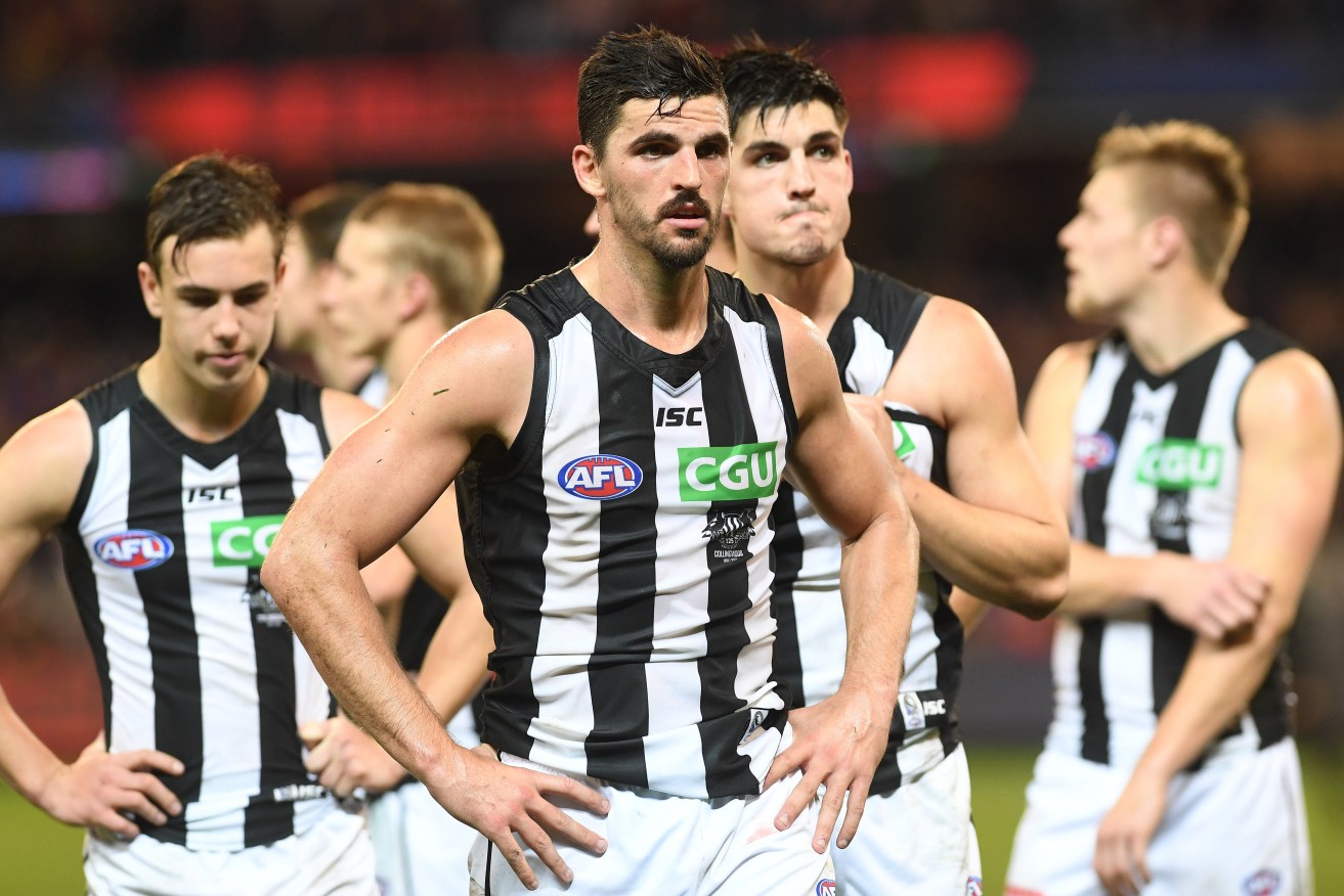 Scott Pendlebury leads the his team from the ground after the heart-stopping loss to the Demons. Photo: Julian Smith / AAP