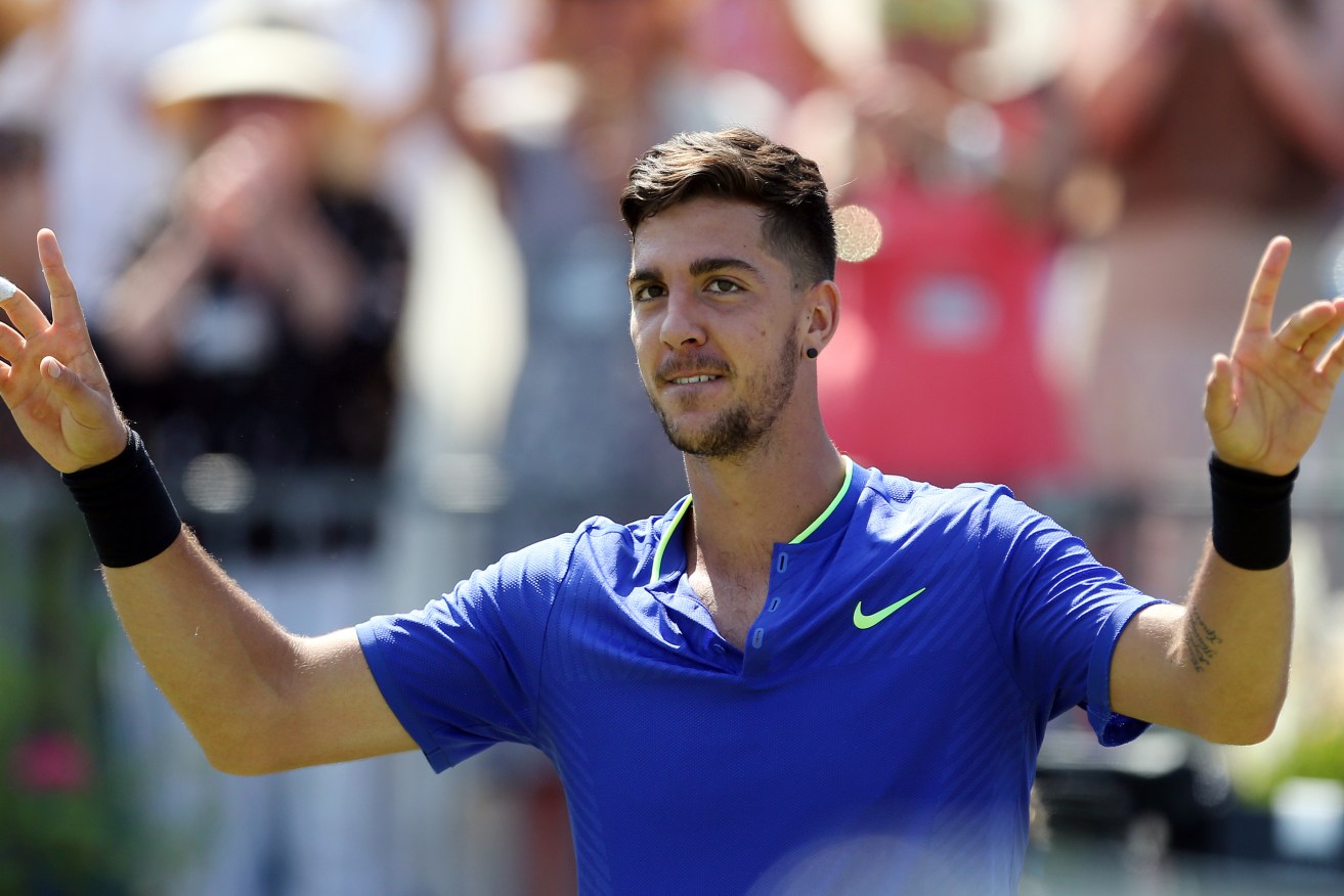Thanasi Kokkinakis celebrates victory at The Queen's Club, London. Photo: Steven Paston / PA Wire