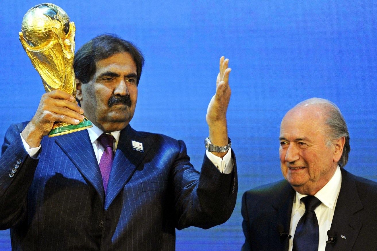 Former FIFA President Joseph Blatter announcing Qatar's winning bid with the Emir of Qatar, Sheikh Hamad bin Khalifa Al-Thani. Photo: WALTER BIERI / EPA