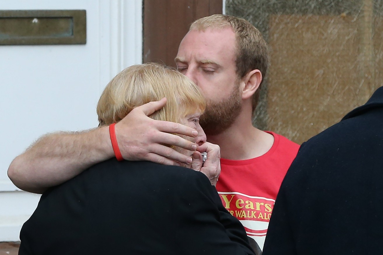 Family members of Hillsborough victims embrace after a meeting with Crown Prosecution Service chief Sue Hemming, who announced criminal charges would be laid. NIGEL RODDIS / EPA