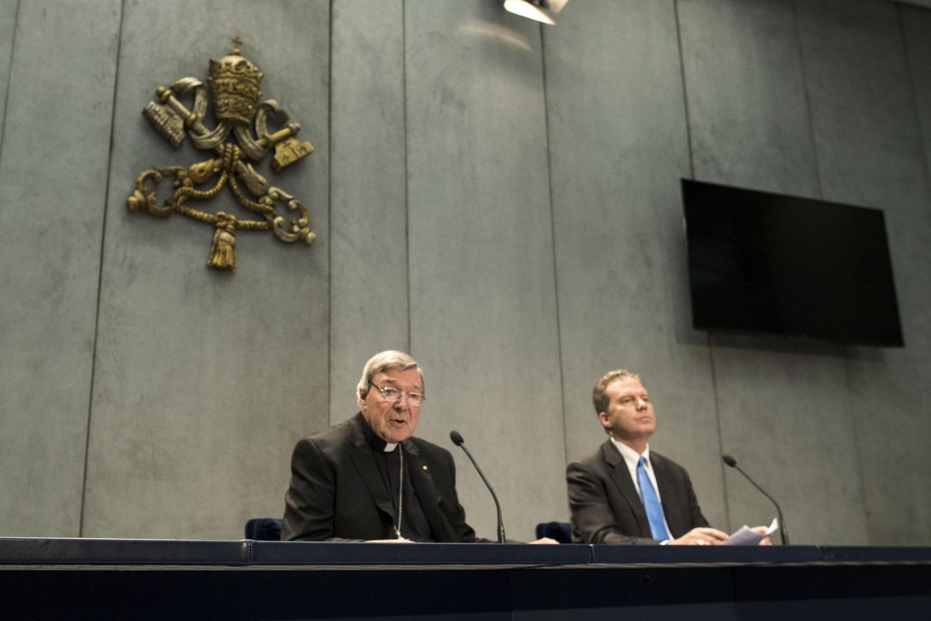 Cardinal George Pell (left) with Vatican spokesman Greg Burke. Photo: EPA/Massimo Percossi