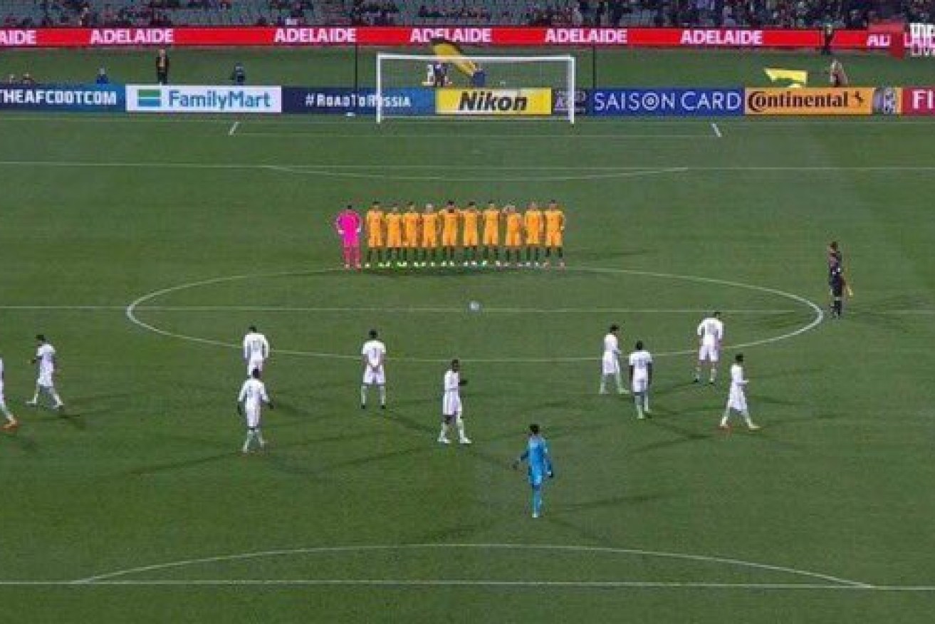The Saudis mill about on the field as the Australians line up for a minute's silence. Photo: Fox Sports broadcast via Twitter