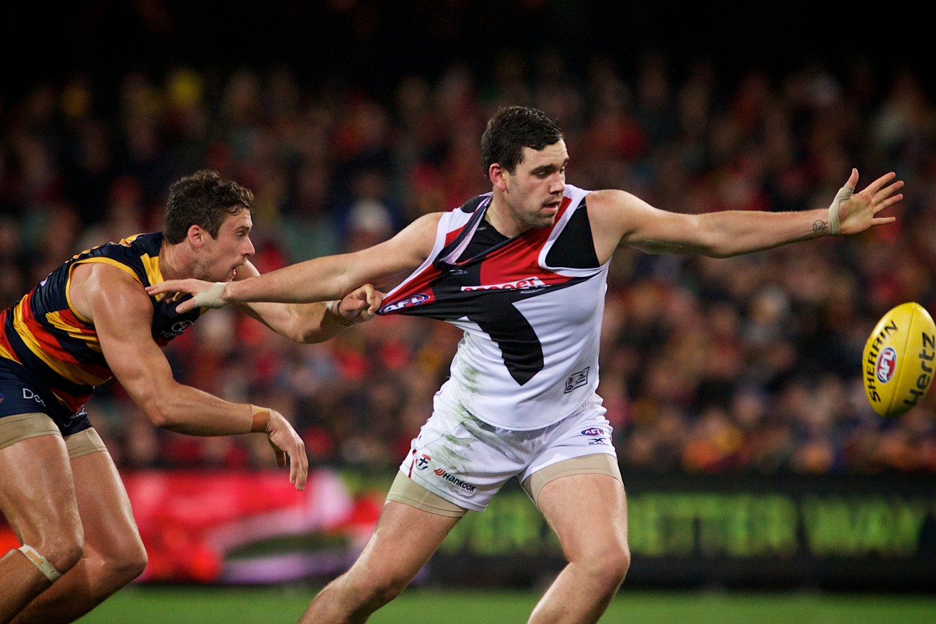 Kyle Hartigan gets a hold of Paddy McCartin's jumper on Friday night. Photo: Michael Errey / InDaily