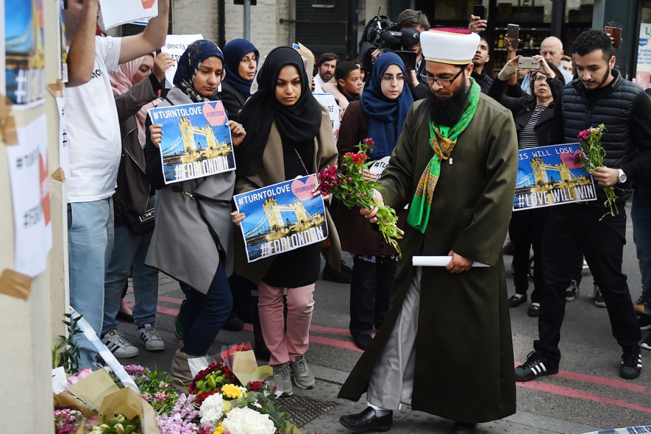 United we stand: members of London's Muslim community place flowers near the site of the attack at Borough Market. Photo: EPA
