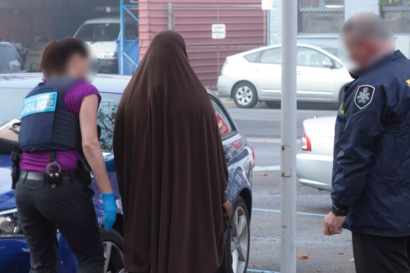 Police making an arrest of an Adelaide woman late last month. She was charged with being a member of the Islamic State terror group. Her lawyers have reportedly indicated she will deny the charge. Photo: AAP