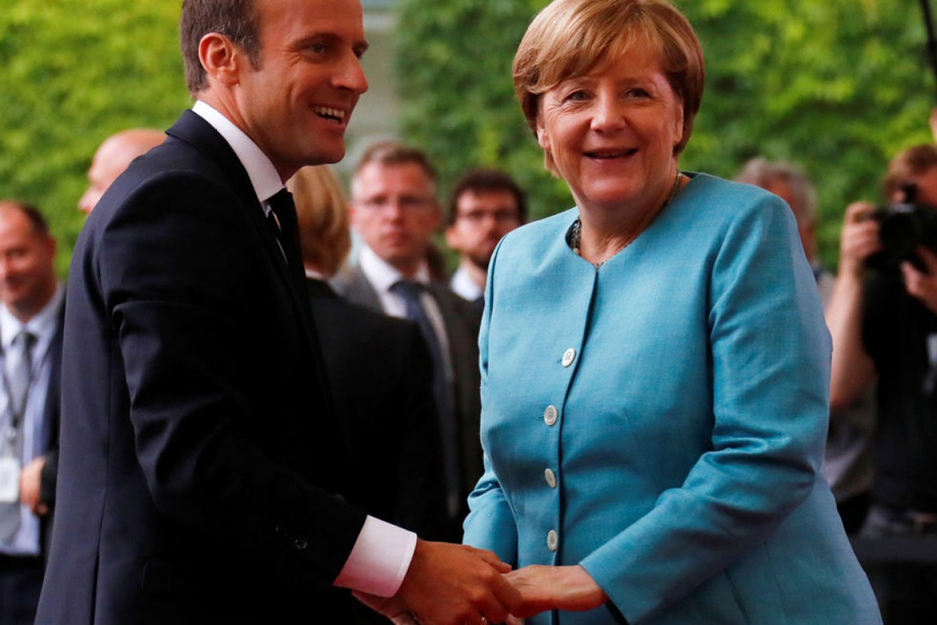 German Chancellor Angela Merkel, pictured here with French President Emmanuel Macron, has managed to keep centrists happy while holding on to her conservative base. Reuters/Fabrizio Bensch
