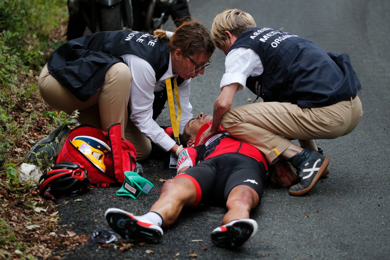 Australia's Richie Porte gets medical assistance after crashing in the descent of the Mont du Chat pass. Photo: Christophe Ena / AP