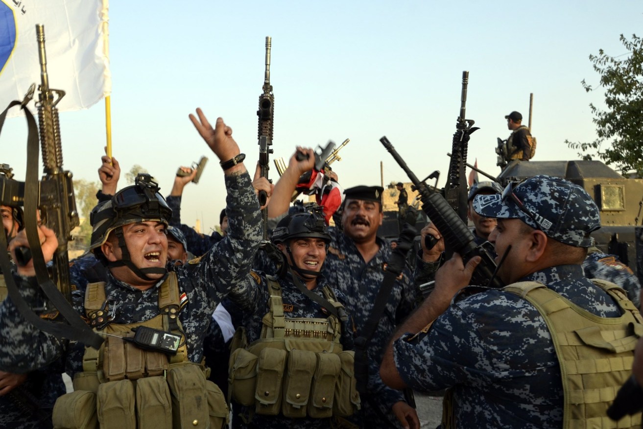 Iraqi soldiers celebrate in central Mosul. Photo: EPA/STR