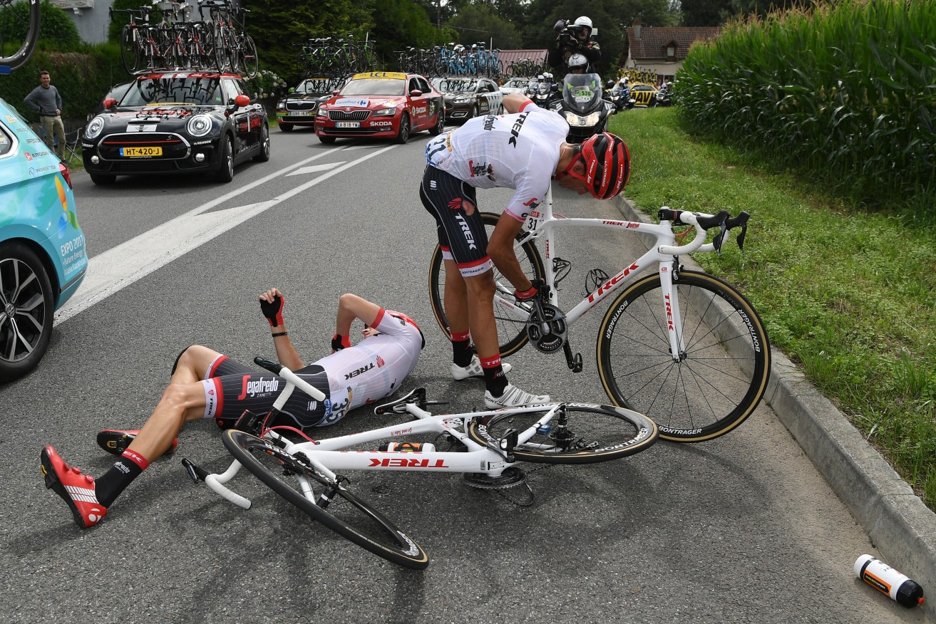 Alberto Contador gets back on his bicycle after crashing with his teammate Michael Gogl. Photo: Franck Faugere / Pool Photo via AP