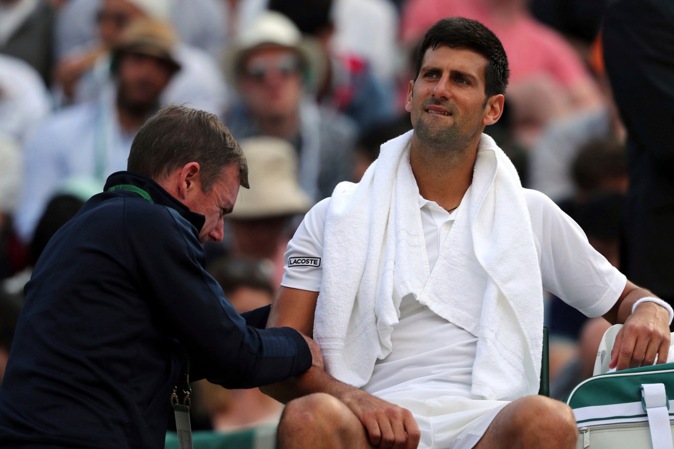 Novak Djokovic receives medical treatment during his match against Czech Republic's Tomas Berdych. Photo: Gareth Fuller / PA via AP