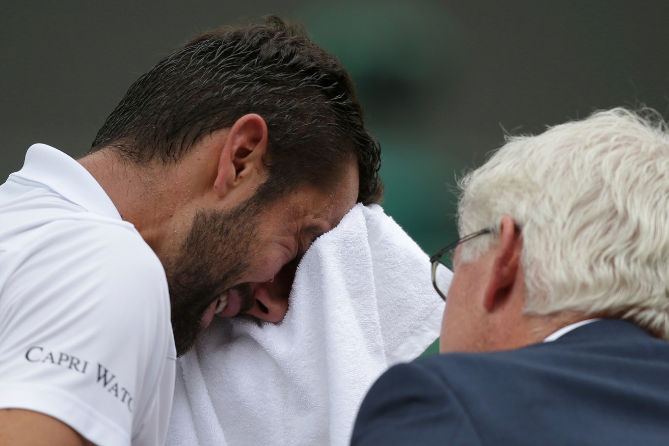 Marin Cilic has treatment on his foot as he takes an emotion-charged medical timeout. Photo: Daniel Leal-Olivas / Pool Photo via AP