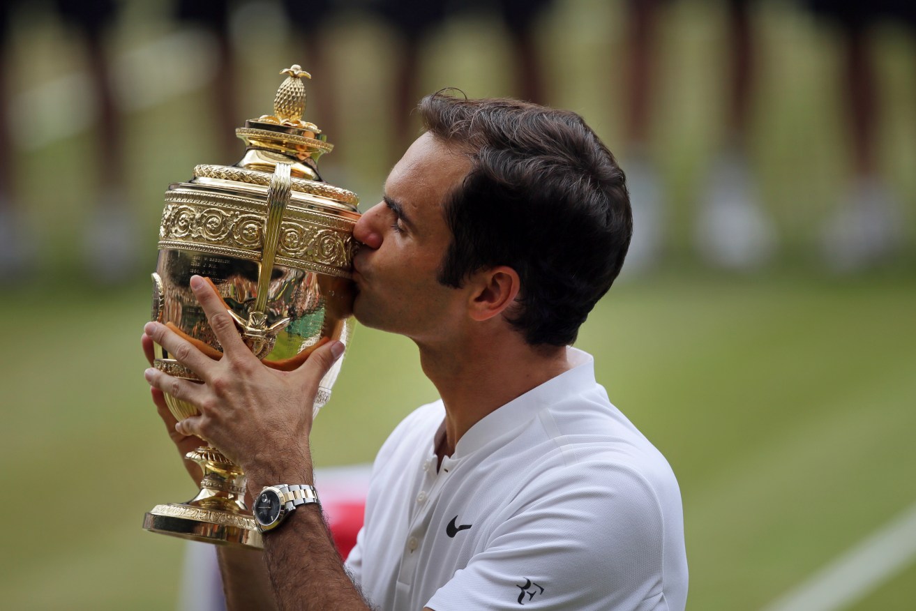 Roger Federer celebrates with the trophy after beating Croatia's Marin Cilic in the Men's Singles final. Photo: Tim Ireland / AP