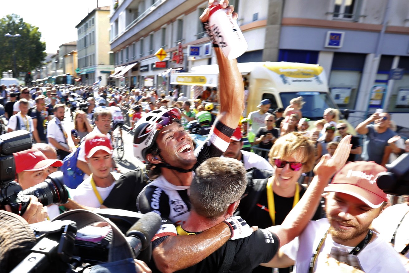 Australian Michael Matthews celebrates with teammates after winning the 16th stage of the Tour de France. Photo: GUILLAUME HORCAJUELO / EPA