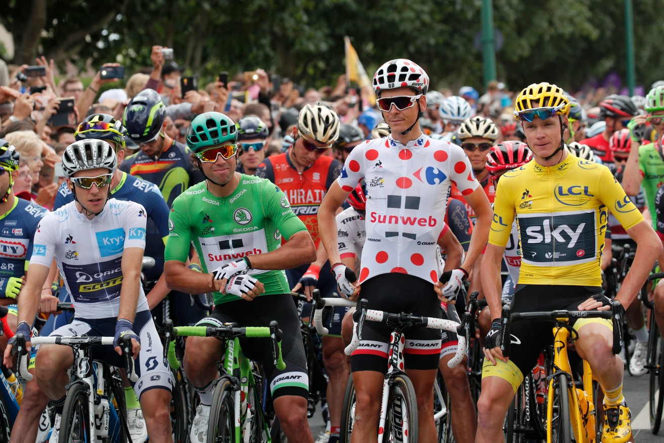 Chris Froome (yellow jersey), Michael Matthews (green), Warren Barguil (dotted jersey) and Simon Yates (white) await the start of the twenty-first and final stage of the Tour de France. Photo: Christophe Ena / AP