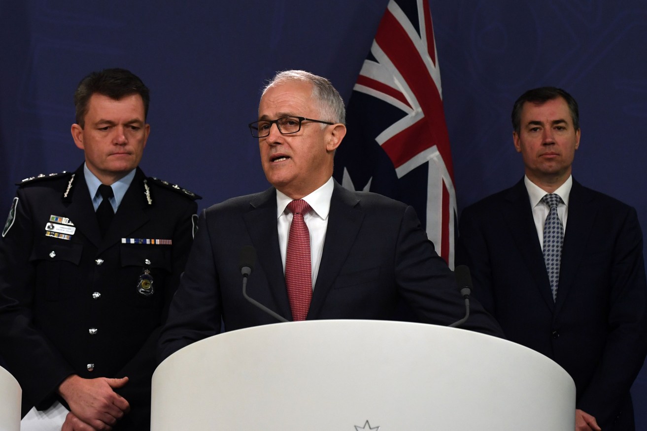 Prime Minister Malcolm Turnbull alongside AFP Commissioner Andrew Colvin (left) and Minister for Justice Michael Keenan (right) on Sunday. Photo: AAP/Sam Mooy