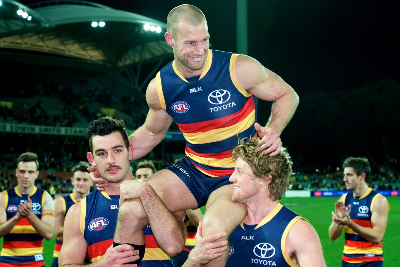 Scott Thompson chaired off Adelaide Oval by Taylor Walker and Rory Sloane after his 300th game last year. Photo: Michael Errey / InDaily