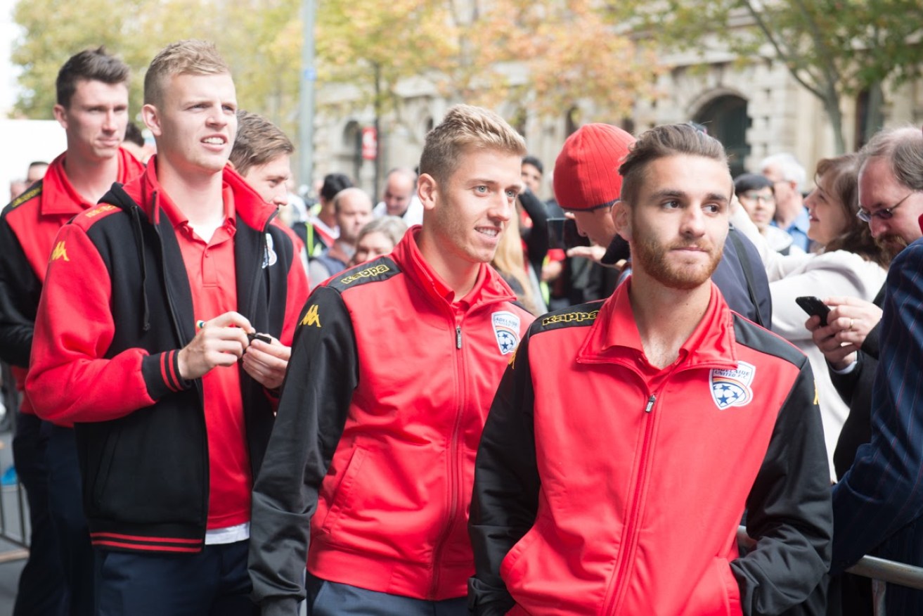 Stefan Mauk (centre, at Adelaide United's championship victory parade last year) is off to Melbourne City. Photo: Nat Rogers / InDaily