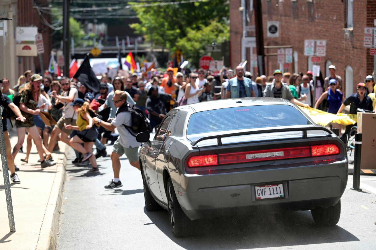 A vehicle drives into a group of protesters demonstrating against a white nationalist rally in Charlottesville. Photo: The Daily Progress via AP