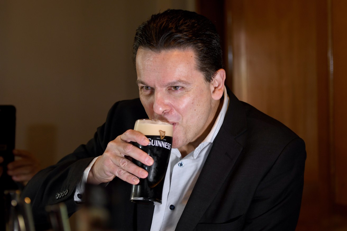 Nick Xenophon makes light of his citizenship debacle with a pint of heavy at The British Hotel in North Adelaide. Photo: Mark Brake / AAP