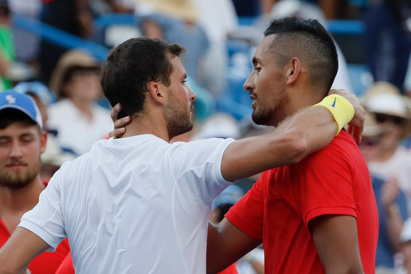Grigor Dimitrov embraces Nick Kyrgios after winning their men's singles final. Photo: John Minchillo / AP