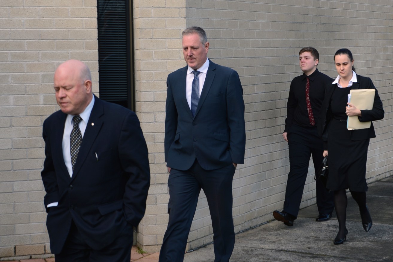 SA Member for Mt Gambier Troy Bell (second left) and his lawyer Bill De Garis (left) arrive at the Mt Gambier Magistrates Court today. Photo: AAP/Lechelle Earl