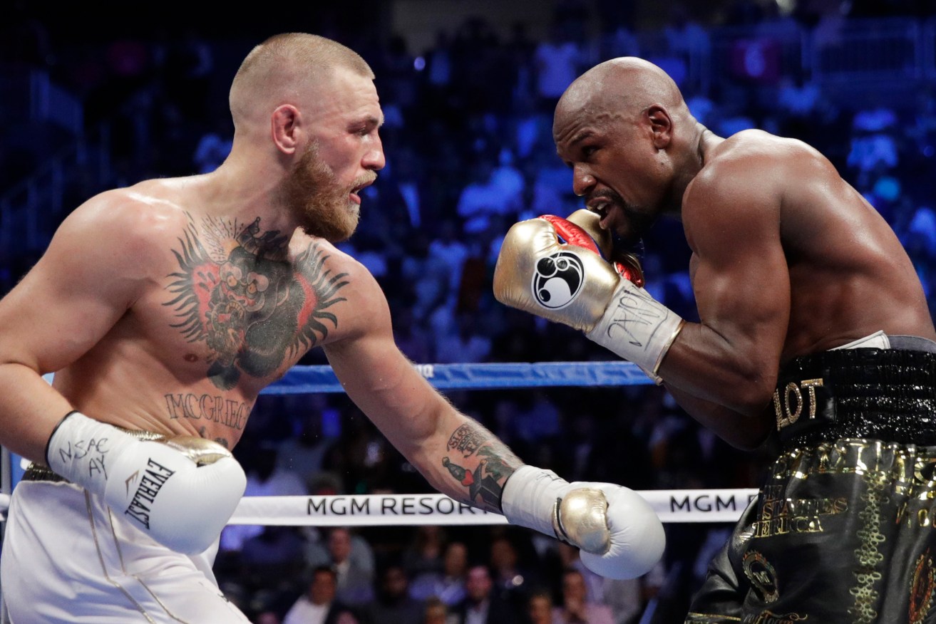 GET IN THE RING: Floyd Mayweather Jr. takes on Conor McGregor yesterday. Photo: Isaac Brekken / AP