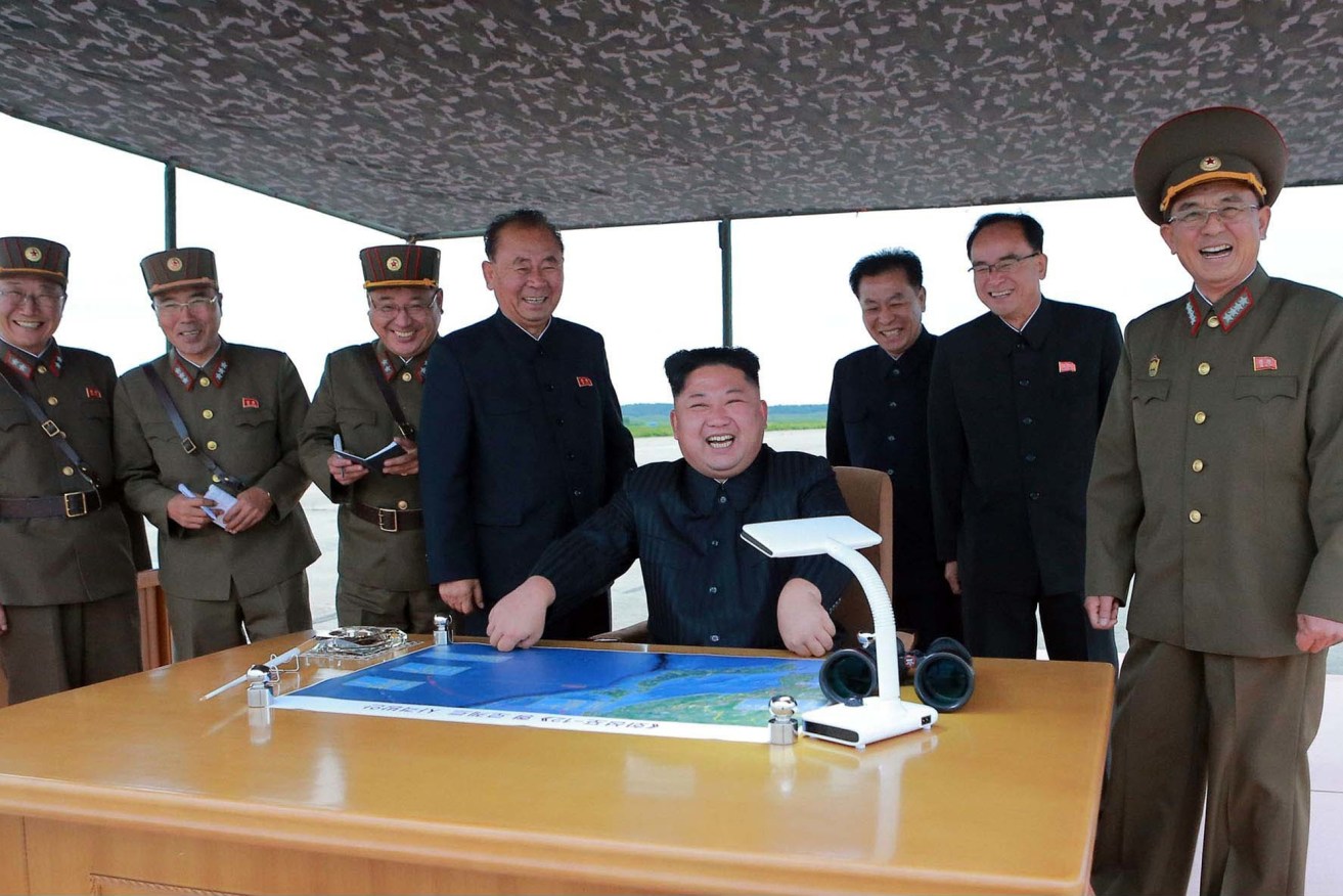 A photo distributed by the North Korean government shows leader Kim Jong Un (centre), purportedly at the launch of the Hwasong-12 intermediate range missile. Photo: Korean Central News Agency/Korea News Service via AP