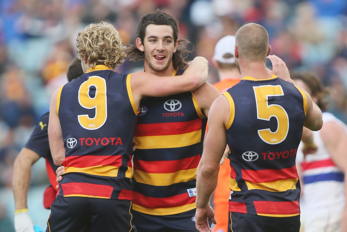 Taylor Walker in 2013 with teammates Rory Sloane and Scott Thompson. Photo: Ben Macmahon / AAP