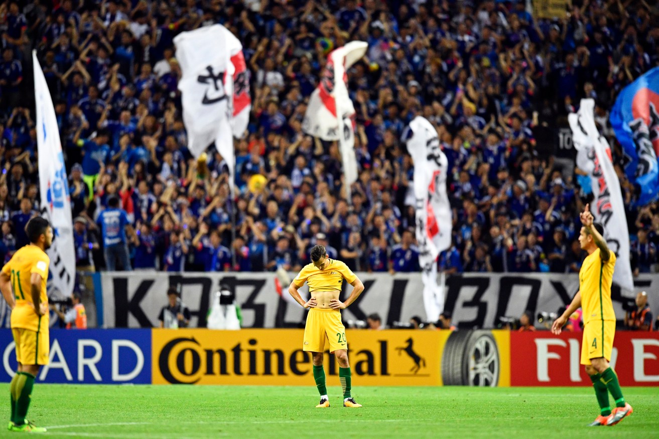 Defender Trent Sainsbury reacts as Japan puts Australia to the sword. Photo: Franck Robichon/EPA