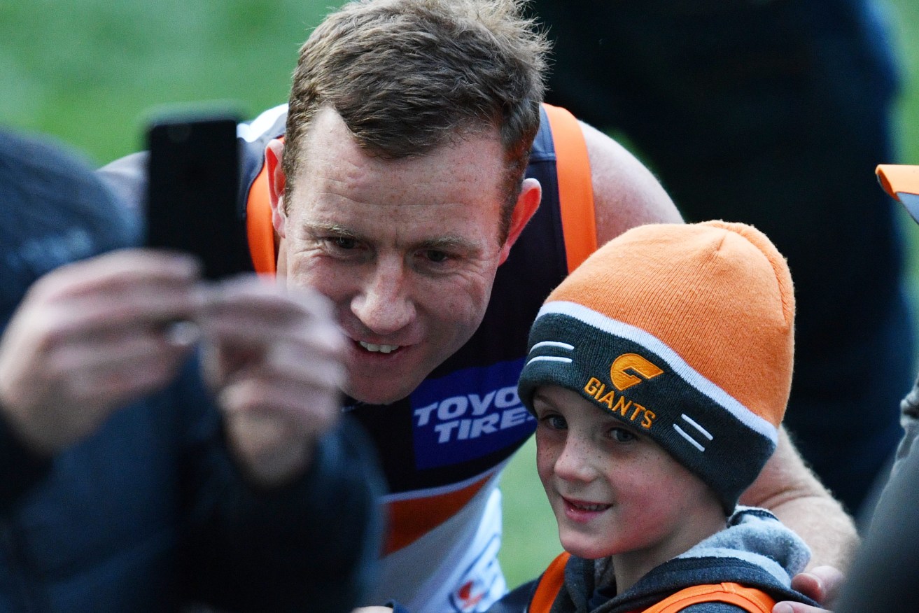 Steve Johnson meets a young Giants supporter at Adelaide Oval yesterday. Photo: David Mariuz / AAP