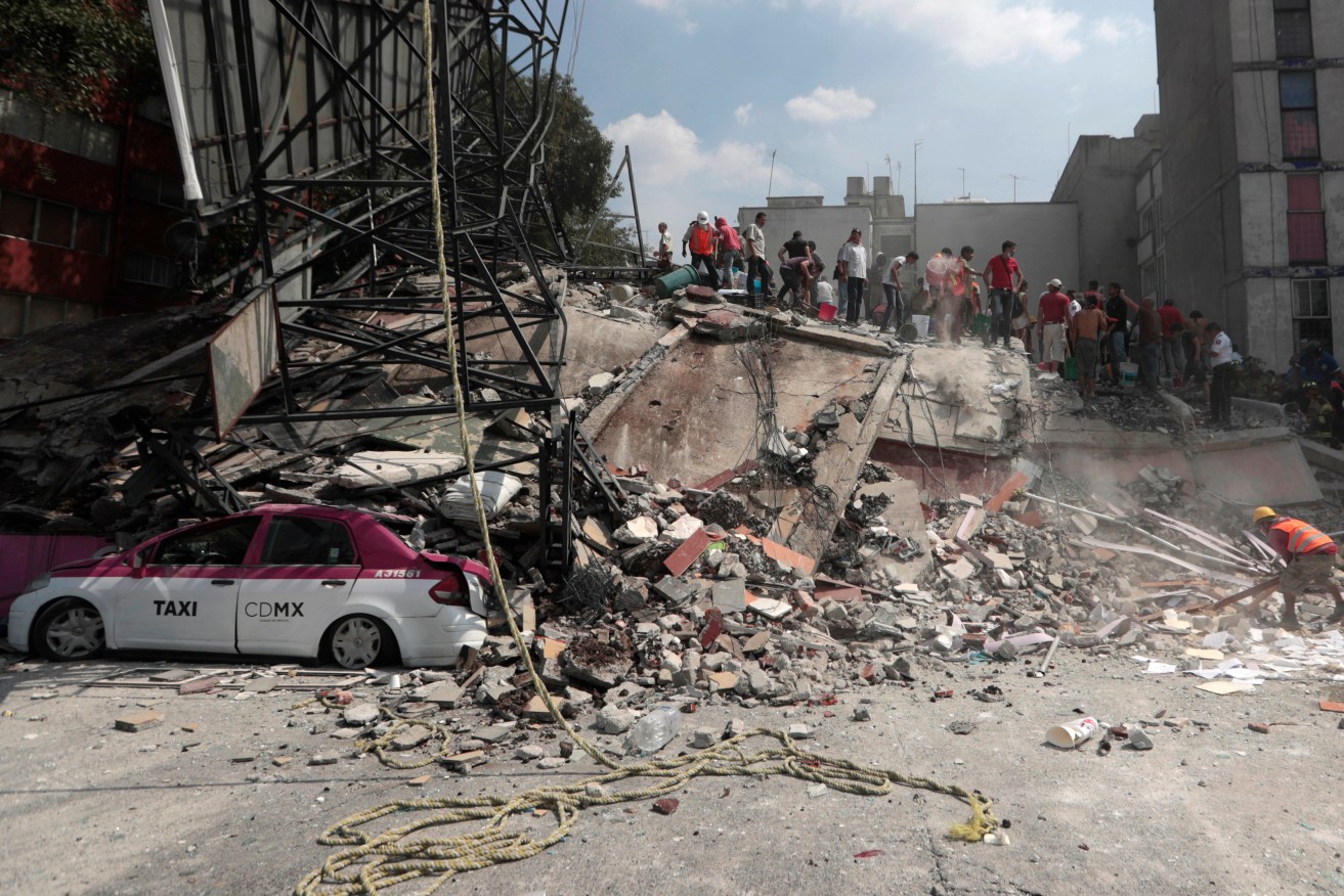 Volunteers search a building that collapsed after an earthquake, in the Roma neighborhood of Mexico City. Photo: AP/Eduardo Verdugo