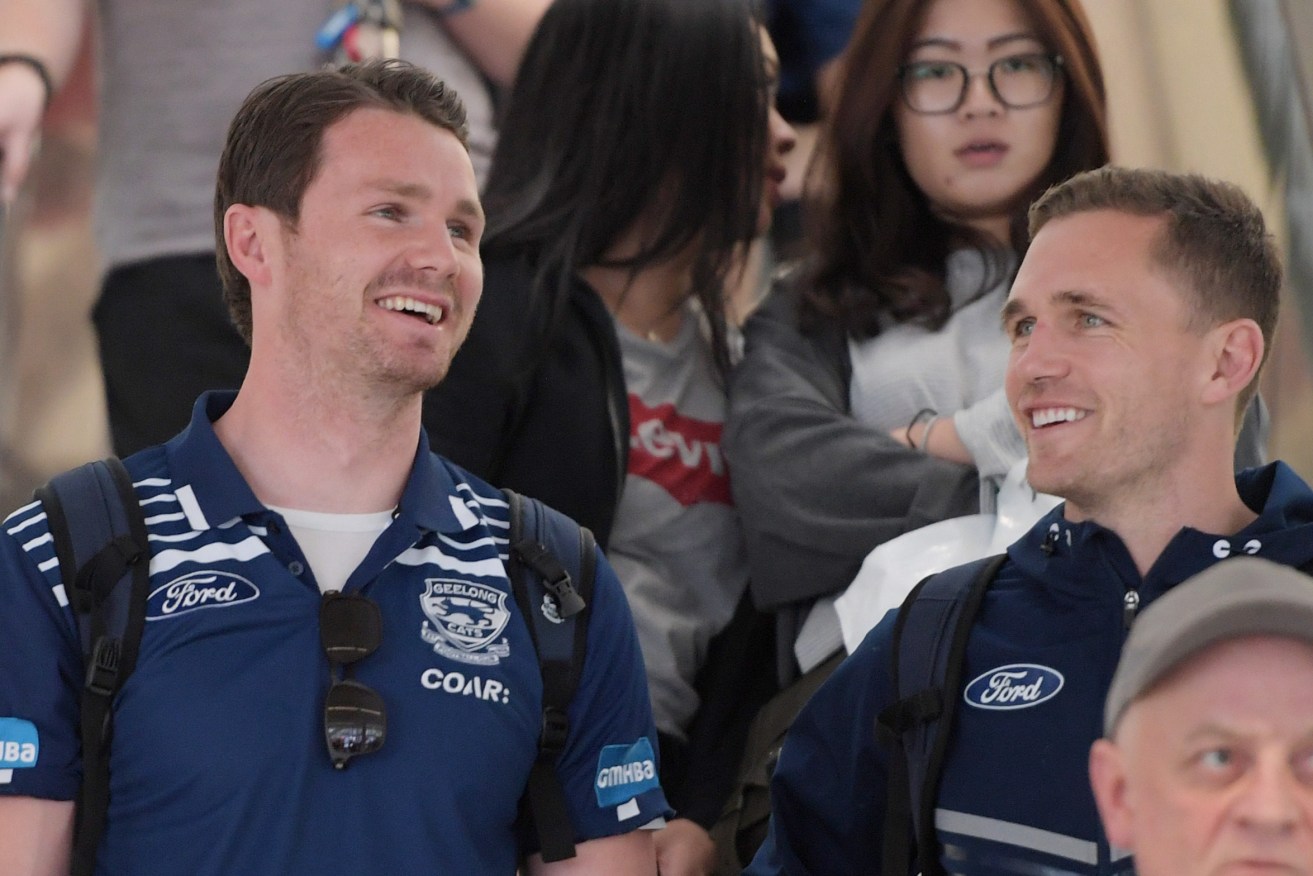 Patrick Dangerfield shares a laugh with skipper Joel Selwood at Adelaide Airport yesterday. Photo: Tracey Nearmy / AAP
