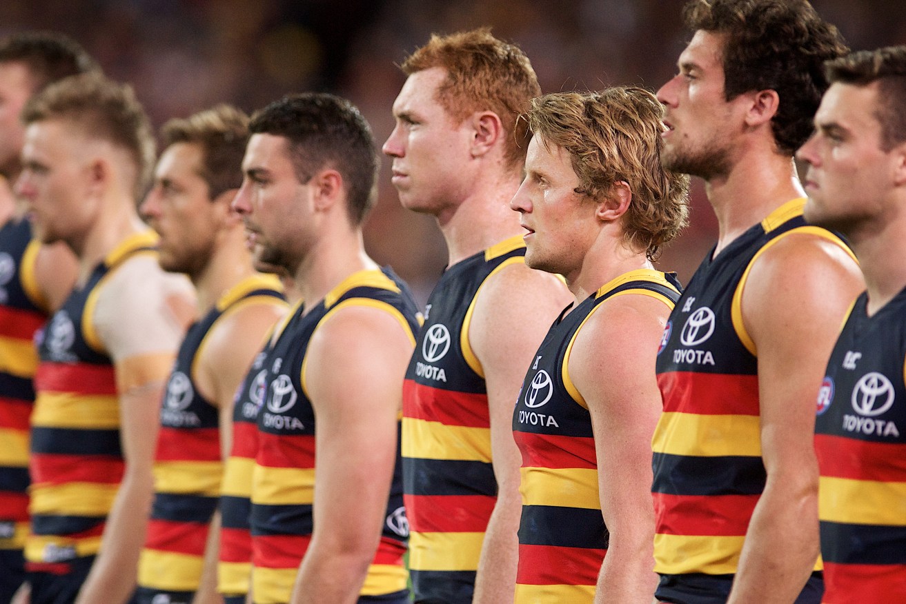 Adelaide players adopt their national anthem stance against Geelong last week. Photo: Michael Errey / InDaily