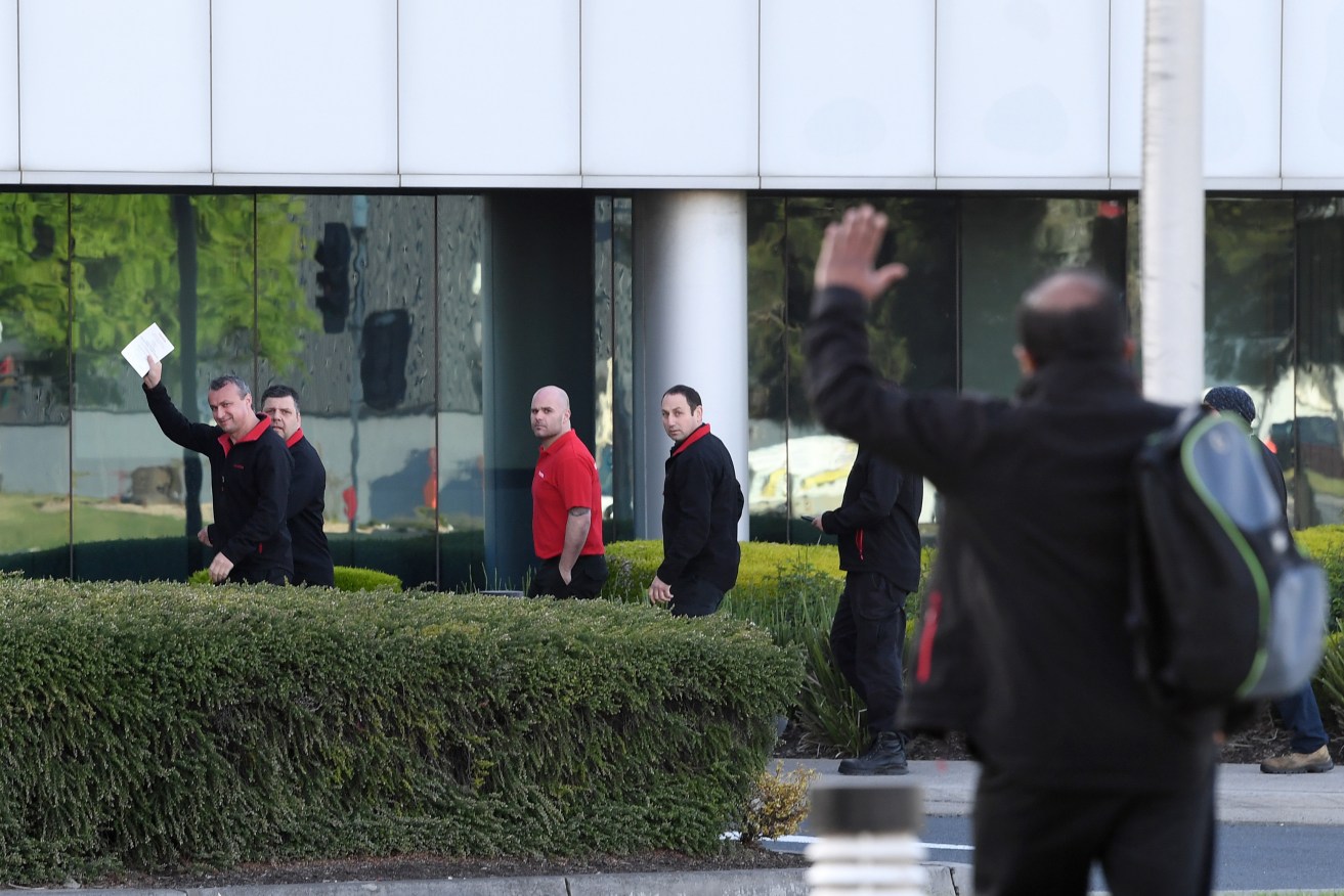 Toyota workers outside the Altona plant this morning. Photo: AAP/Joe Castro
