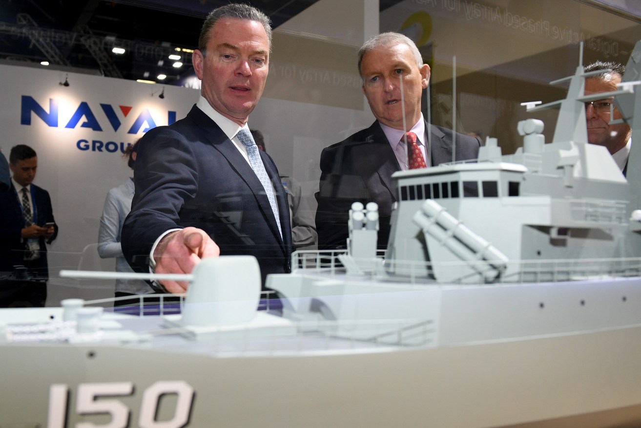 Defence Industry Minister Christopher Pyne inspects a scale model of an Anzac class frigate at a Maritime expo this month. Photo: Dan Himbrechts / AAP