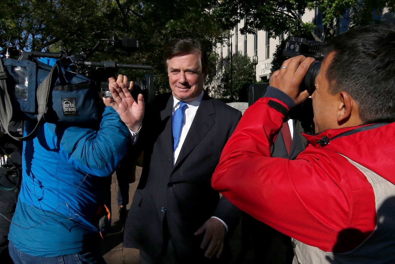 Paul Manafort makes his way through television cameras as he walks from Federal District Court in Washington. Photo: AP/Alex Brandon