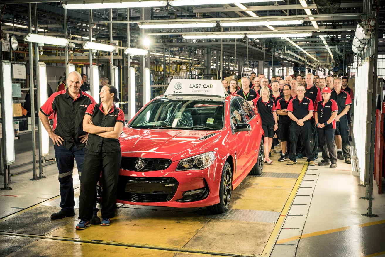 Holden workers at Elizabeth with the last car off the production line today. Photo: Randy Larcombe / Supplied by GMH
