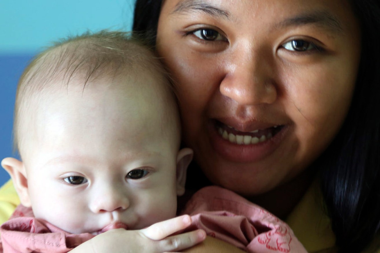 Thai surrogate mother Pattaramon Chanbua with Gammy in 2014. The baby boy was born with Down Syndrome and subsequently abandoned by his Australian commissioning parents. Photo: AP