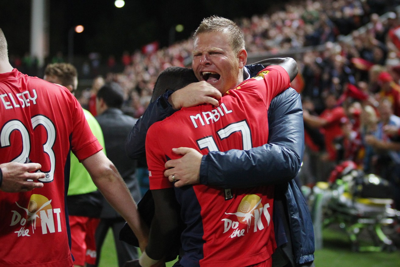 Then Adelaide United coach Josep Gombau celebrates with Awer Mabil after a comeback against Melbourne Heart in 2014. Photo: AAP/Ben MacMahon