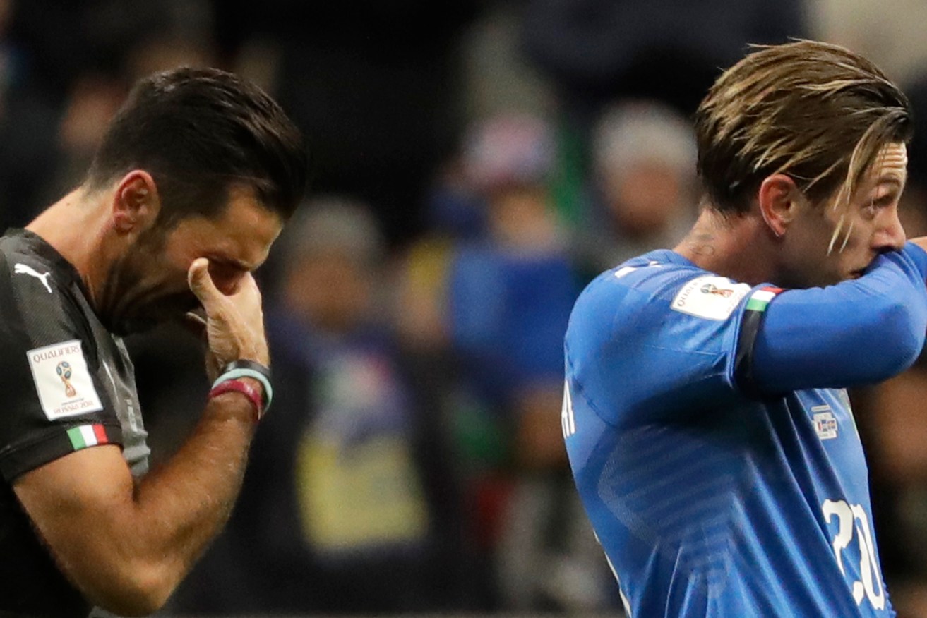 Italy's goalkeeper Gianluigi Buffon and Manolo Gabbiadini react to their team's elimination in the World Cup qualifying play-off against Sweden. Photo: Luca Bruno / AAP