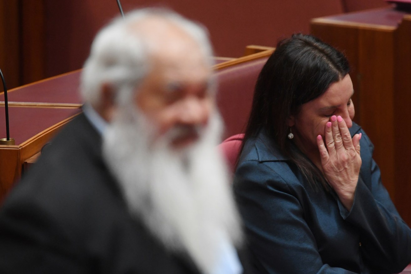 Tasmanian Senator Jacqui Lambie reacts as she listens to Labor Senator Pat Dodson after delivering a statement on her resignation in the Senate chamber today. Photo: AAP / Lukas Coch