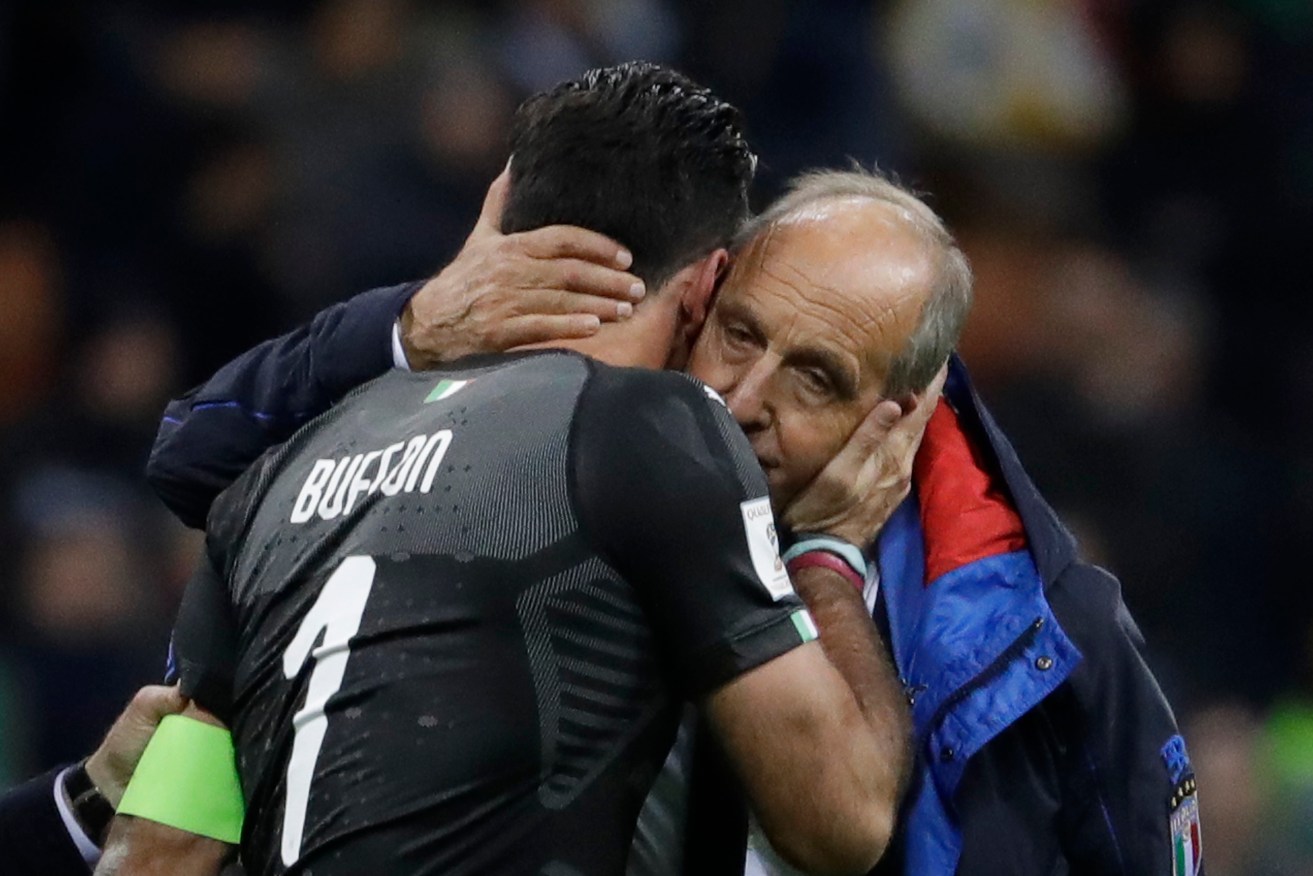 Retiring Italy goalkeeper Gianluigi Buffon is comforted by coach Gian Piero Ventura after this week's qualifying nightmare. Photo: Luca Bruno / AP
