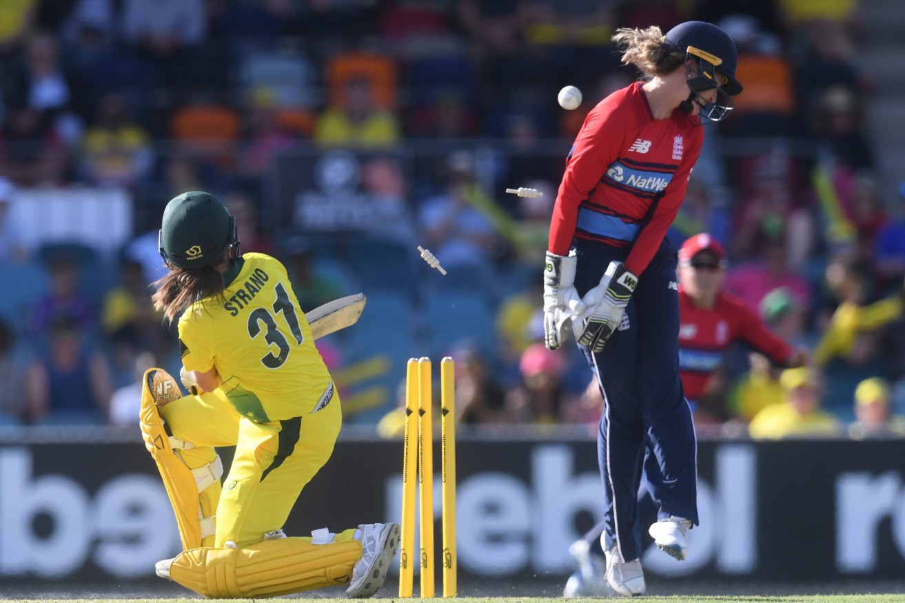 Australia's Molly Strano is bowled during yesterday's T20 Ashes loss at Manuka Oval. Photo: Lukas Coch / AAP