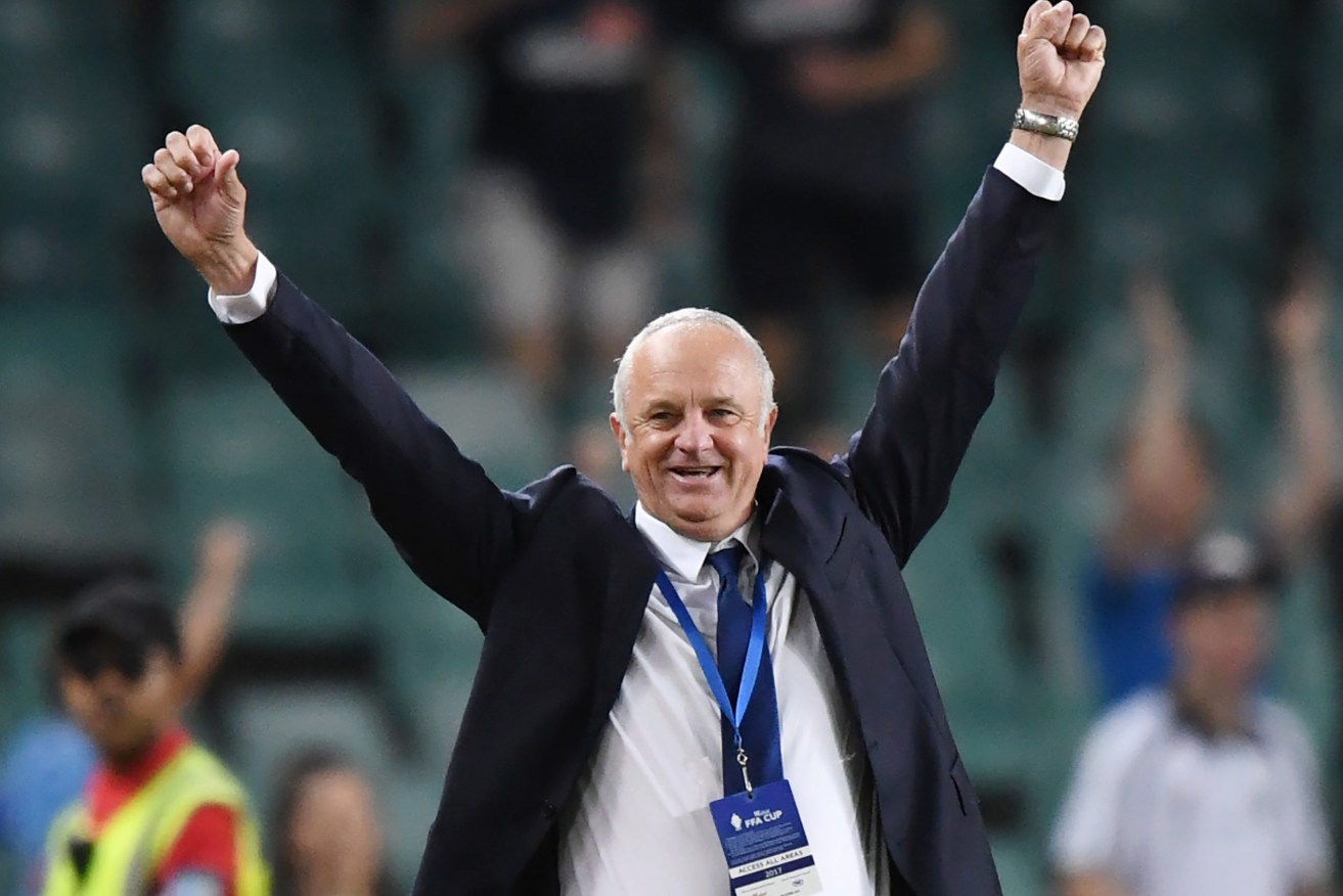 Graham Arnold celebrates victory over Adelaide United in the FFA Cup final. Photo: David Moir / AAP