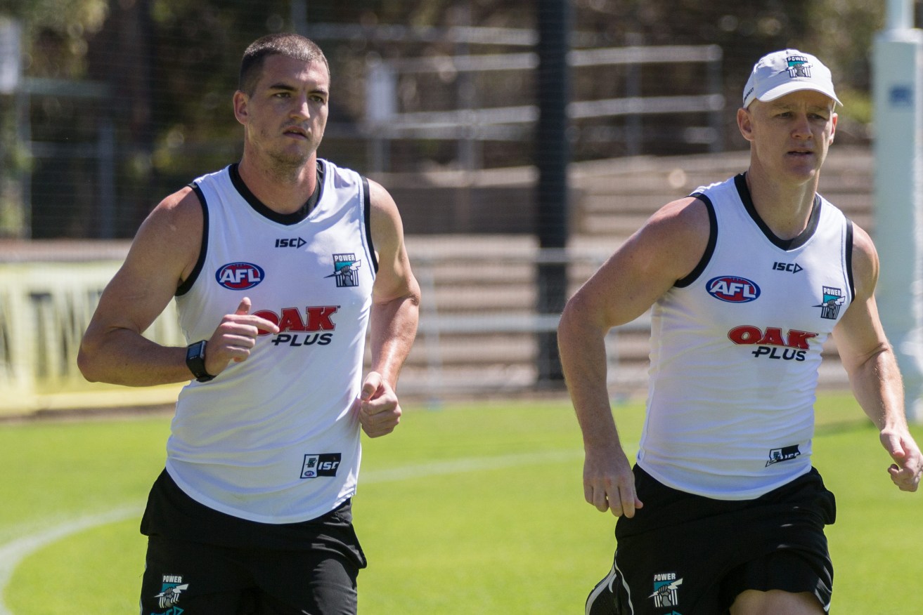 ROCK N' ROBBIE: New Power recruit Tom Rockliff and veteran Robbie Gray on the training track yesterday. Photo: Ben Macmahon / AAP